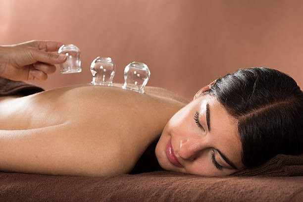 Cupping therapy on back with glass cups